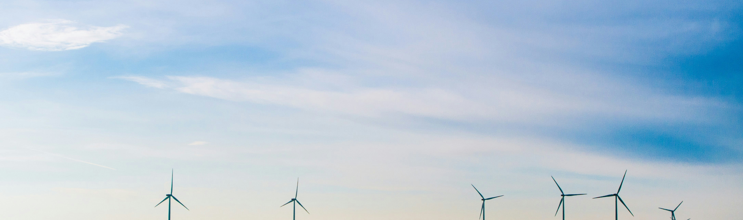 https://unsplash.com/photos/white-windmills-on-green-grass-field-under-white-clouds-and-blue-sky-ZKWgoRUYuMk