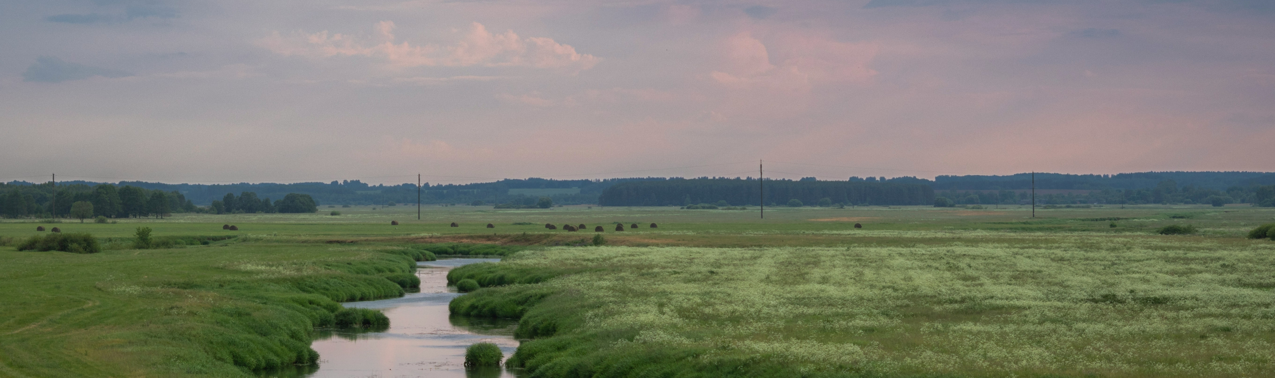 https://unsplash.com/photos/a-river-running-through-a-lush-green-field-oLJLVzUGRU0