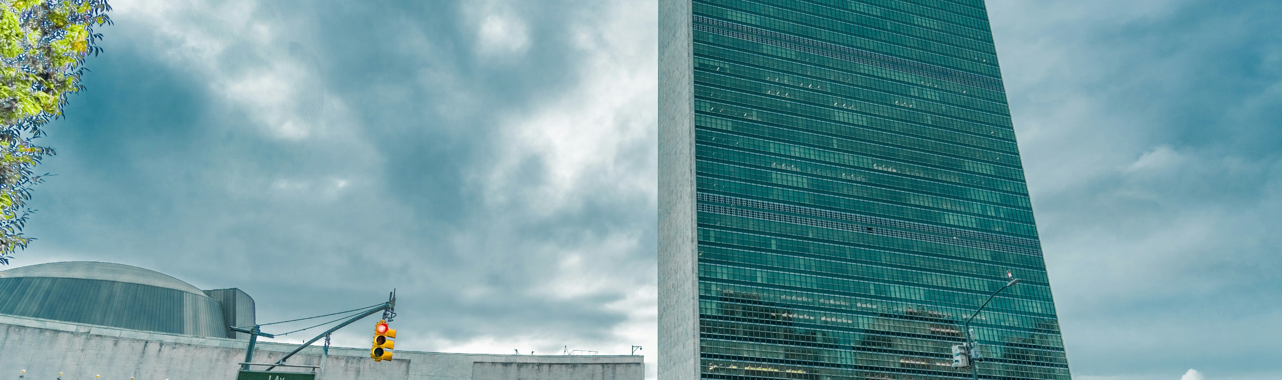 https://unsplash.com/photos/a-very-tall-building-sitting-next-to-a-body-of-water-fqzMMzpoUs4